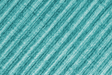 Ridge macro texture of velour corduroy turquoise cloth. Large ribbed, diagonal coarse weaving velveteen, striped upholstery texture fabric background, furniture textile material, design, decor
