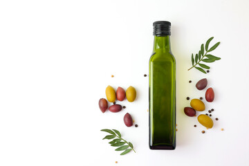 A beautifully arranged Olive Oil Bottle alongside Fresh Olives and vibrant Green Leaves 