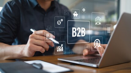 Man using laptop with business to business concepts displayed