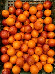 Box with ripe fresh organic tangerines on the shelf of a fruit supermarket are displayed for sale