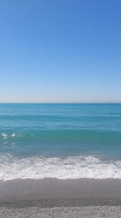 Coastal Serenity: A Picturesque Beach Scene with Gentle Waves and a Clear Sky