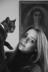 black and white portrait with a beautiful girl and a cat