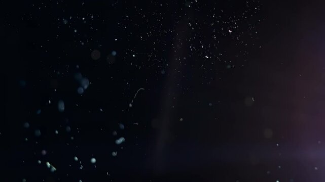 4K Real floating dust particles in dark atmosphere, slow motion background, abstract overlay, fine particle texture, digital design resource, glowing air particles, cinematic visual effect