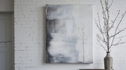 modern abstract painting in gray tones hangs on white brick wall, complemented by minimalist vase with branches, creating serene and artistic atmosphere