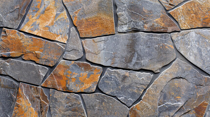 Fototapeta premium Natural stone wall with textured slate tiles in earthy tones