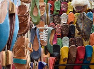 Slippers or sandals of many colors hung from street stalls in Marrakech's souk