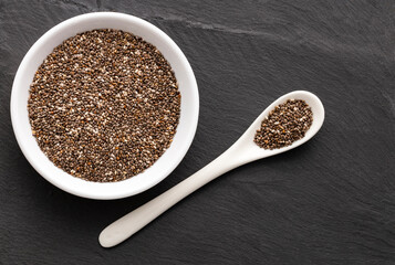 Organic chia seeds in the bowl and spoon - Salvia hispanica.