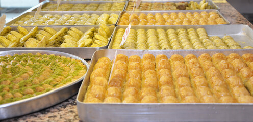 Traditional Baklava Varieties and Trays on the Counter