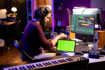 Professional artist editing audio recordings on daw software interface, working on music industry...