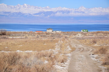 Lake Issyk Kul in Kyrgistan with snowy mountains in the background.