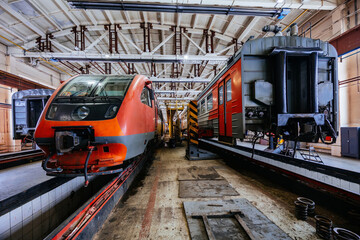 Electric trains at service in train repair workshop