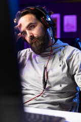 Professional gamer interacting with fans during livestream, disappointed after losing esports match. Man streaming in studio, unhappy with being defeated in online multiplayer videogame © DC Studio