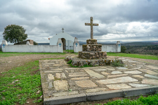 Catholic crucifix in stone on the right side, chapel sra das Neves on the left side. Castelo Branco District