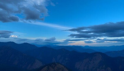 Obraz premium Majestic Twilight Mountain Range Silhouette Under Blue Sky