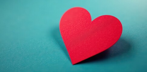 Obraz premium Close-up of a single red heart-shaped adhesive sticker, detail, white