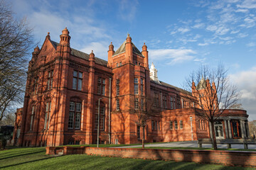 Stunning red brick architecture of the University of Manchester Museum, captured under a clear blue...