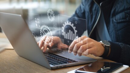 Person using laptop with digital data and gear overlays