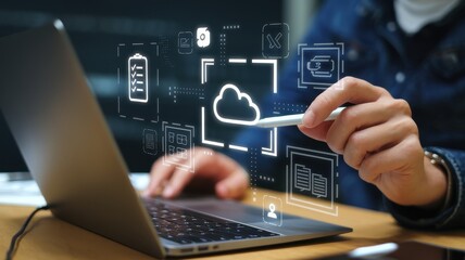 Person using laptop and stylus with cloud computing interface