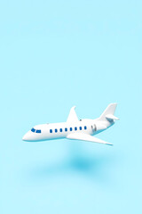 Naklejka premium white airplane model on light blue background