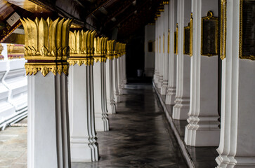 Serene temple corridor with golden pillars in Wat Phra Kaew Bangkok Thailand