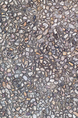Textured stone surface with small pebbles and gravel