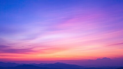 Obraz premium A beautiful twilight sky with a gradient of deep blue, purple, and soft orange tones.