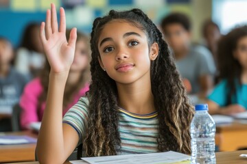 Confident high school student raising hand in classroom: answering question