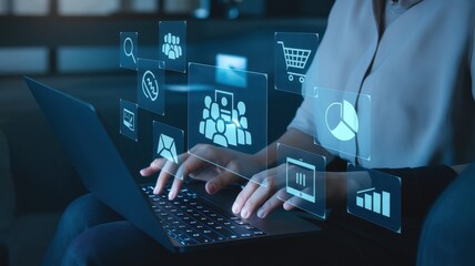 Woman interacting with virtual interface while working on laptop