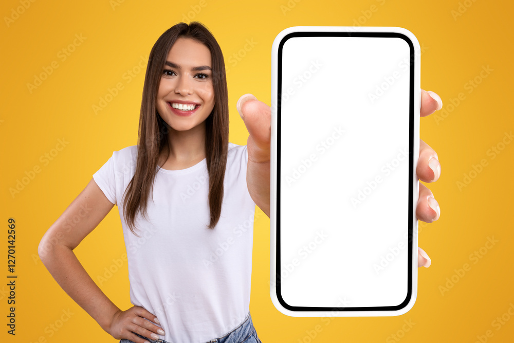 Poster Mobile App Advertisement. Excited Woman Showing White Empty Smartphone Screen Recommending App Posing Over Orange Studio Background, Smiling To Camera. Check This Out, Cellphone Display Mock Up