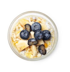 Delicious chia pudding with blueberries, banana and oatmeal in glass isolated on white, top view