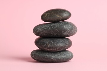 Stack of rocks on pink background. Harmony and life balance