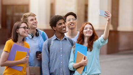 Happy Student Girl Making Group Selfie With Coursemates On First Day Of Study At University Standing Outdoor.