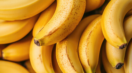 full frame close up of ripe, yellow bananas stacked closely together