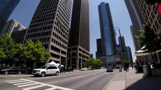 Wide-angle video capturing a skyline view of modern skyscrapers along a waterfront, under a clear blue sky, showcasing urban architecture.