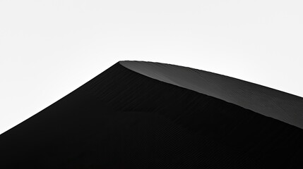 Abstract close-up of a smooth, curved black surface against a soft white background
