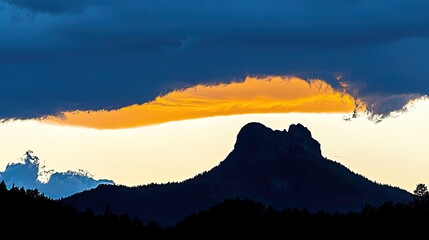 Majestic sunset over a mountain silhouette with dramatic clouds and vibrant colors in the sky