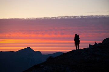 Fototapeta premium Majestic Mountain Landscape with Vibrant Red and Orange Sky, Atmospheric and Serene