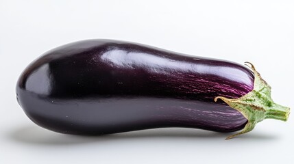 A whole purple eggplant with a smooth surface, placed on a white background.