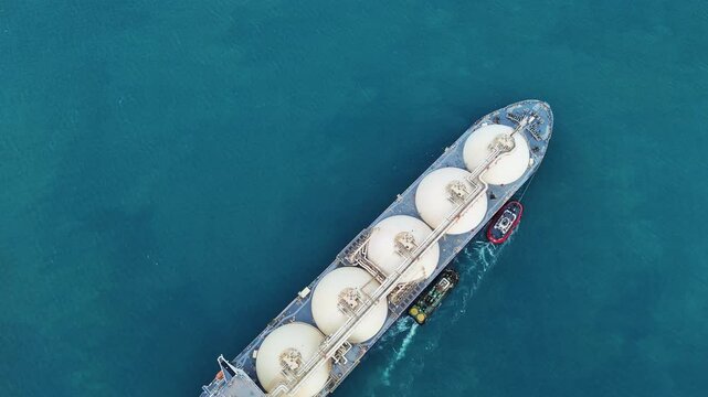 LNG (Liquified Natural Gas) tanker anchored in Gas terminal gas tanks for storage. Oil Crude Gas Tanker Ship. LPG at Tanker Bay Petroleum Chemical or Methane freighter export import transportation 