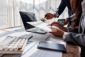 Team of business people working together in the meeting room office, teamwork background charts and...