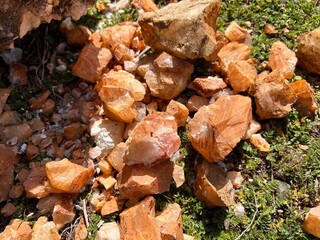 Marble Fragments from a Marble Quarry on Green Grass