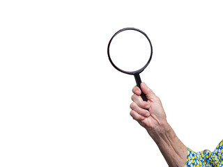 Senior hand holding magnifying glass – search, focus, and inspection concept.