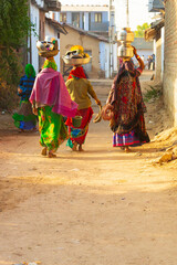 Asia, India, North Gujarat.Rann. Kankrej Taluka. Kankrej Village women headed to the wells with pots on head.