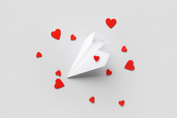 Paper airplane with red hearts on white background. Valentine's Day celebration