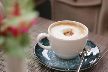 Enjoying a warm cup of coffee at a cozy cafe in the morning