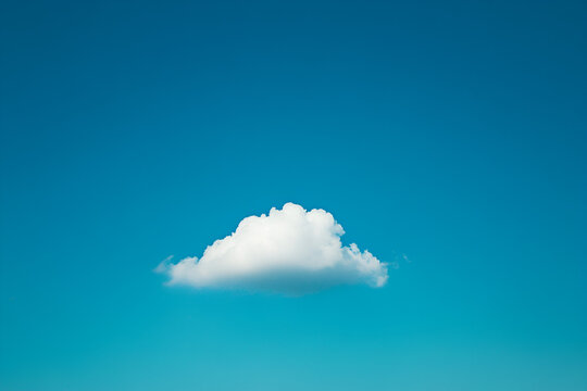 Serene Sky: A solitary, fluffy cloud floats effortlessly against an expansive canvas of vibrant blue, inspiring tranquility and simplicity.