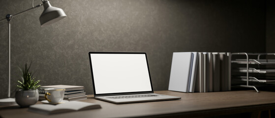 A modern dark loft office workspace features a laptop and decorative items on a wooden desk.