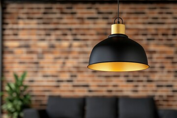 Obraz premium Industrial Chic: A single black and gold pendant lamp with a matte finish hanging in front of a blurred urban loft interior. 