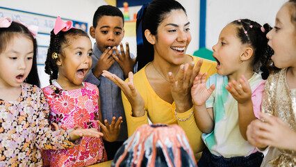 Teacher and group of children learning at nature science at kindergarten class, Diverse students...