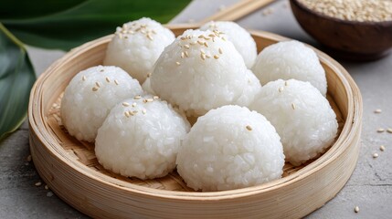 Fototapeta premium Soft White Rice Balls with Sesame Seeds on a Wooden Plate
